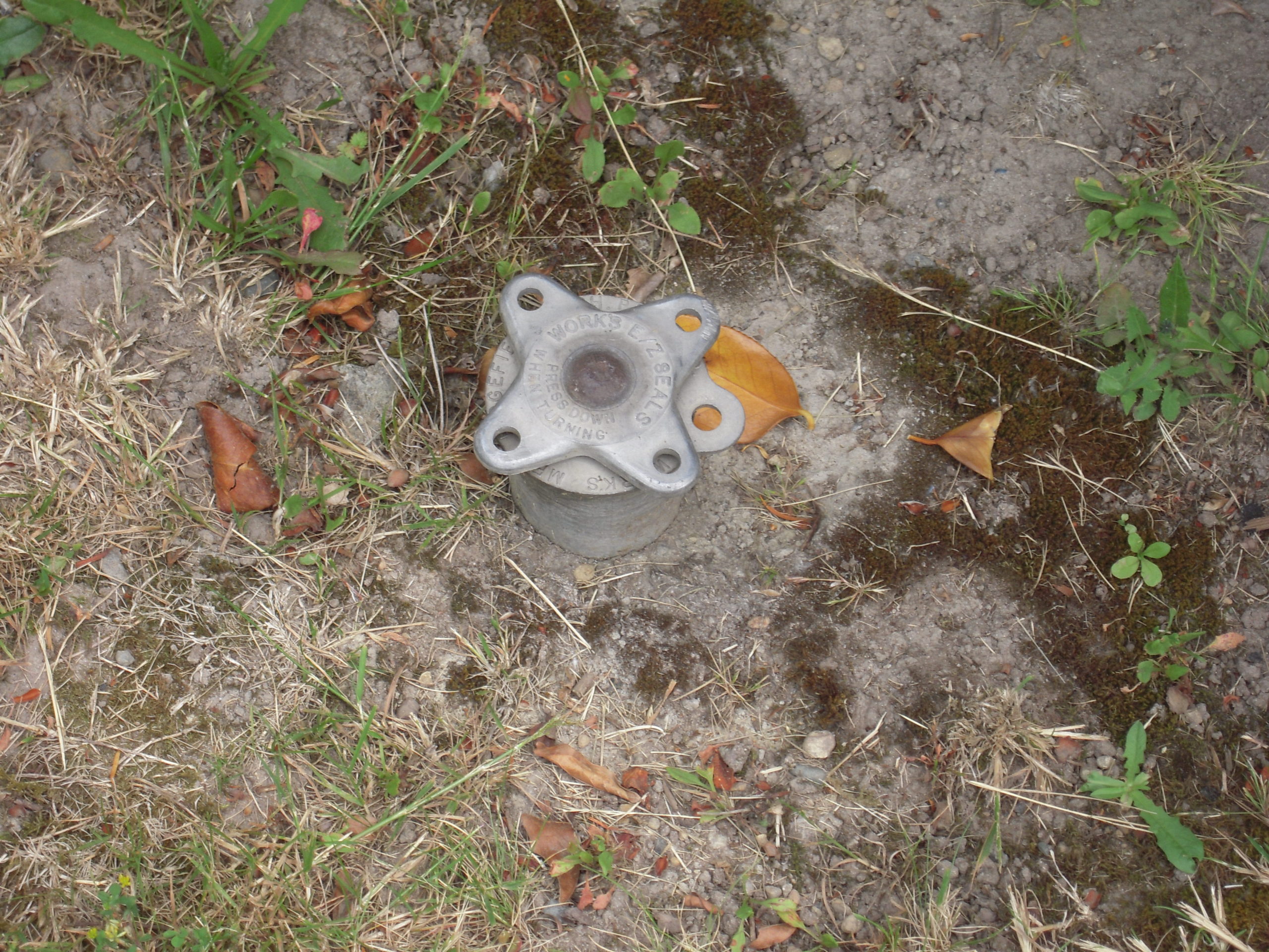 Dylan Chalk photo of an oil tank fill valve in the grass